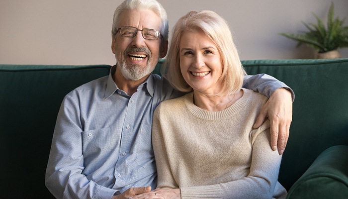Man and woman smiling with dentures in Sweeny