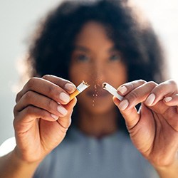 Closeup of patient breaking cigarette