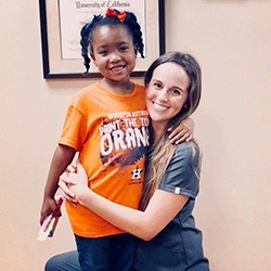 Team member hugging young patient