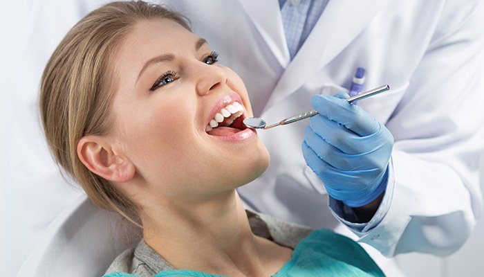 Woman receiving dental exam