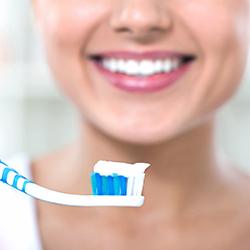 Patient holding toothbrush with toothpaste