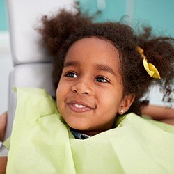 Smiling young girl in dental chair