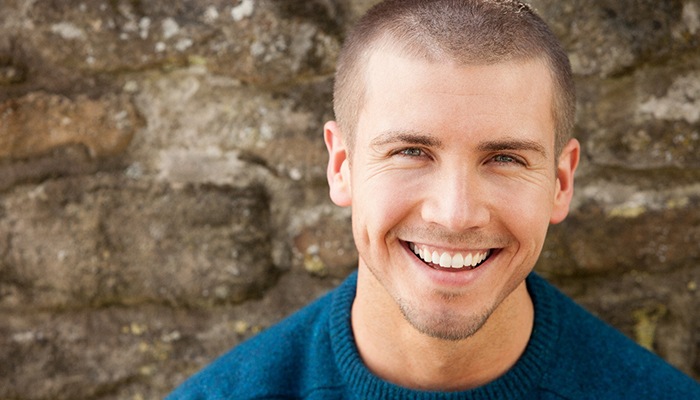 man smiling with dental crowns in Sweeny 