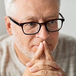 Man with glasses thinking