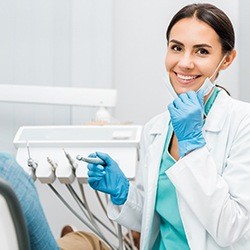 Dentist smiling while treating patient