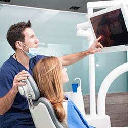 Emergency dentist in Sweeny showing patient an X-ray