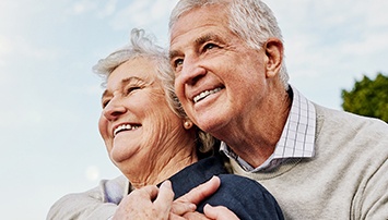 Smiling older man and woman outdoors