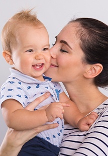 woman holding her smiling infant