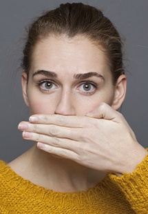 woman hiding her smile