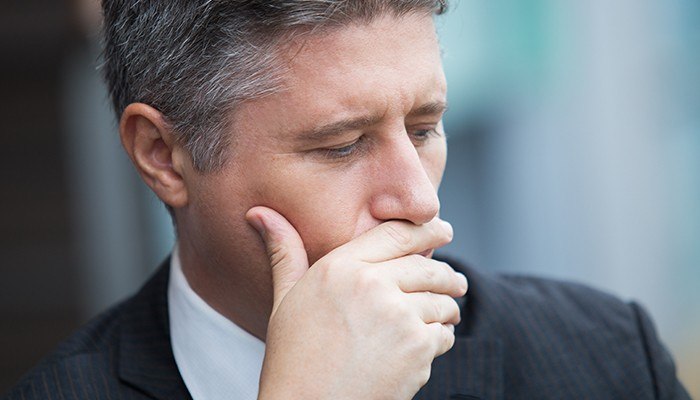 Man covering his mouth