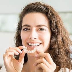 Woman placing Invisalign tray