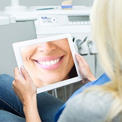 Woman looking at her smile in mirror
