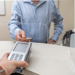 A man paying the cost of veneers