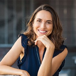 Woman standing outside in city and smiling