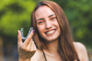 Someone holding an Invisalign tray