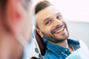 Young man smiling in dentist's chair.