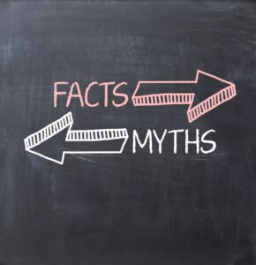 “Facts” and “Myths” written on chalkboard, with arrows pointing in opposite directions