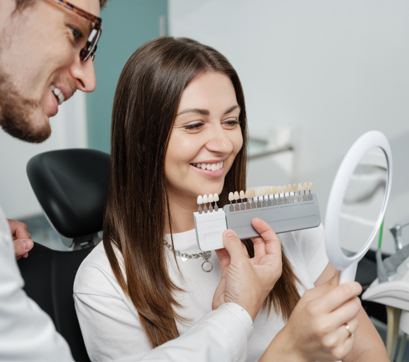 Dentist showing patient veneer options